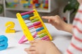 A small child learns to count on abacus, mathematics, arithmetic for children. Royalty Free Stock Photo