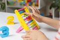 A small child learns to count on abacus, mathematics, arithmetic for children. Royalty Free Stock Photo