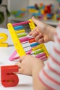 A small child learns to count on abacus, mathematics, arithmetic for children. Royalty Free Stock Photo