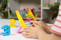 A small child learns to count on abacus, mathematics, arithmetic for children. Royalty Free Stock Photo