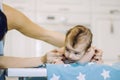 Small child learns to help parents keep his head