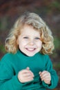 Small child with long blond hair laughing