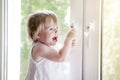 Small child near window. lock on handle of window. Child`s safet Royalty Free Stock Photo