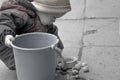 A small child is working collecting garlic in a bucket