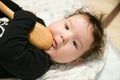 A small child is playing with a spoon. old kitchen toys. close up of babies hands playing with wooden spoon and pot baby chef Royalty Free Stock Photo