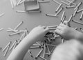 A small child plays with matches, takes matches from the table, close-up, black and white, fire, matches and child Royalty Free Stock Photo