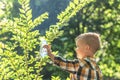 A small child pours water from a bottle on a hot day
