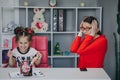 Small child practicing articulation with therapist at private lesson at home