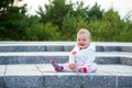 A small child sits on the ground Royalty Free Stock Photo