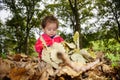 Small child sitting among autumn leaves under trees in Cornwall Park Royalty Free Stock Photo