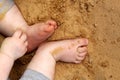 Small child sitting on the sand visible toe-toes Royalty Free Stock Photo