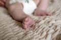 Small child is sleeping in a diaper. Adorable baby feet closeup. Cute little infant sleeping. Selective focus Royalty Free Stock Photo