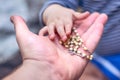 A child takes a rosary from his dad`s hand