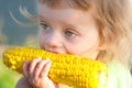 Small child to eat boiled corncob