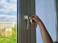 Small child is trying to open window in apartment