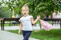 A small child is walking down the street with a backpack. The concept of school, study, education, childhood Royalty Free Stock Photo