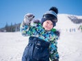 A small child walks in the winter Park. Playing and smiling baby on white fluffy snow. Active rest and games. Royalty Free Stock Photo