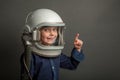 a Small child wants to fly an airplane wearing an airplane helmet