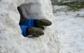 A small child in winter coveralls walks will build an igloo. little boy sticks his hands out of an ice cave, hole, house. He has g Royalty Free Stock Photo