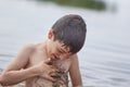 Small children bathe in water smear dirt on their body and rejoice Royalty Free Stock Photo