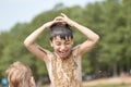 Small children bathe in water smear dirt on their body and rejoice