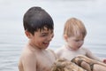 Small children bathe in water smear dirt on their body and rejoice Royalty Free Stock Photo