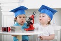 Small children in blue graduation hat adjust Royalty Free Stock Photo