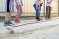 Small children boys and girls playing games - jump over the rope getting ready to jump. Perspective on the legs Royalty Free Stock Photo