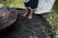 Small children's feet stand on small black decorative stones near the fountain