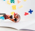 A Small Children`s Violin and Bow on a Child`s Study Desk