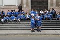 Small children from school sitting on the steps of the entrance to the Lima Cathedral in Peru.