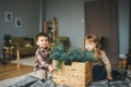 Small children sit on the floor with box of fir Royalty Free Stock Photo