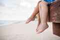 Small children sitting on the wooden pier in the water and enjoying summer day. Bare feet of boy and girl. Vacation Royalty Free Stock Photo