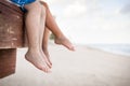 Small children sitting on the wooden pier in the water and enjoying summer day. Bare feet of boy and girl. Vacation Royalty Free Stock Photo