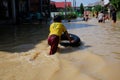 small children swim and play in the water in the flood disaster. Bontang, East Kalimantan, Indonesia. April 26 2022