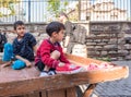 small children transporting on wooden wheel car of junkman