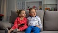 Small children watching television at night caught by parents, entertainment Royalty Free Stock Photo