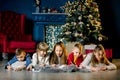 Small children write a letter of wishes to Santa and tell each other Christmas stories