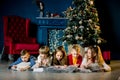 Small children write a letter of wishes to Santa and tell each other Christmas stories