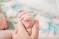 Small children& x27;s pens. Parents gently hold small children& x27;s hands. Close-up of the baby& x27;s hand and parents Royalty Free Stock Photo