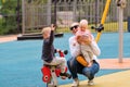 Young mother with children on playground