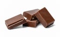 Small chocolate bars in a chaotic mess on a white isolated background. Close distance.