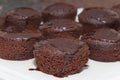 Small chocolate cakes with dripping chocolate icing on top