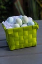 Chocolate eggs in a green presentation basket