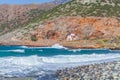 Small Christian church on a rocky shore near the sea