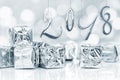 2018, small Christmas gifts in shiny silver paper, bokeh lights Royalty Free Stock Photo