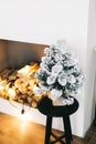 Small Christmas tree in bright white living room on the table Royalty Free Stock Photo