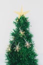 Small Christmas tree decorated with snowflake-shaped lights on the white background Royalty Free Stock Photo