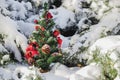 Little Christmas tree with toys in the snow