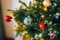 A small Christmas tree in a pot, decorated with balls, garlands Royalty Free Stock Photo